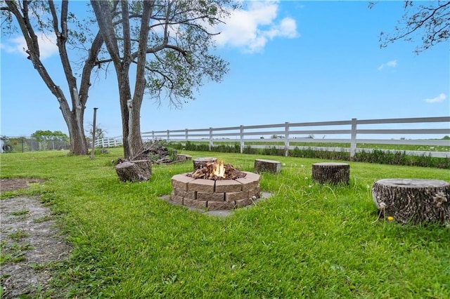 view of yard featuring an outdoor fire pit