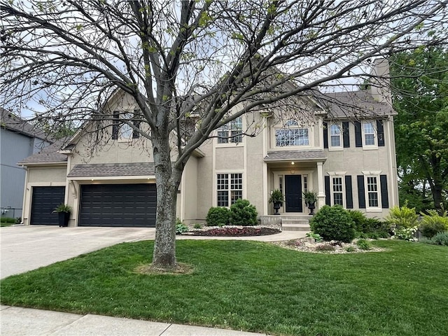 view of front of house featuring stucco siding, a front yard, a chimney, and driveway