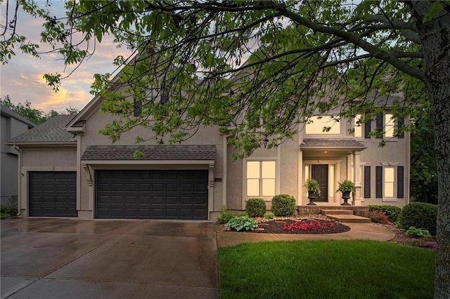 view of front of house featuring concrete driveway, an attached garage, and stucco siding