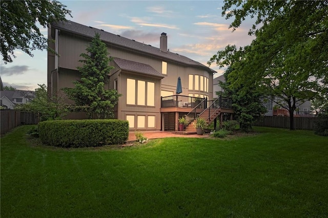 rear view of property featuring stairs, a wooden deck, and a chimney