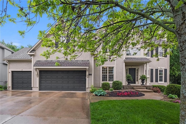view of front of home featuring concrete driveway, stucco siding, a garage, and a front yard
