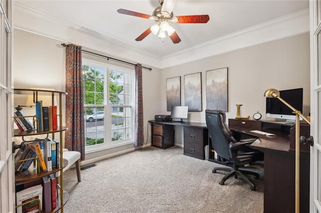 home office featuring carpet floors, ornamental molding, and a ceiling fan