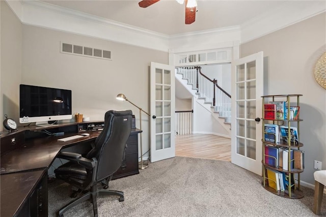 carpeted office space with french doors, crown molding, a ceiling fan, and baseboards