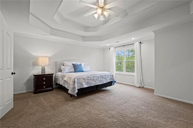 bedroom featuring a tray ceiling, carpet flooring, baseboards, recessed lighting, and ceiling fan