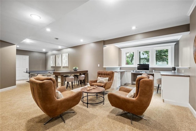 living area with recessed lighting, baseboards, light colored carpet, and crown molding