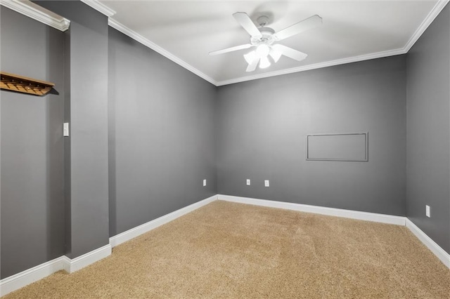 carpeted spare room with ceiling fan, crown molding, and baseboards