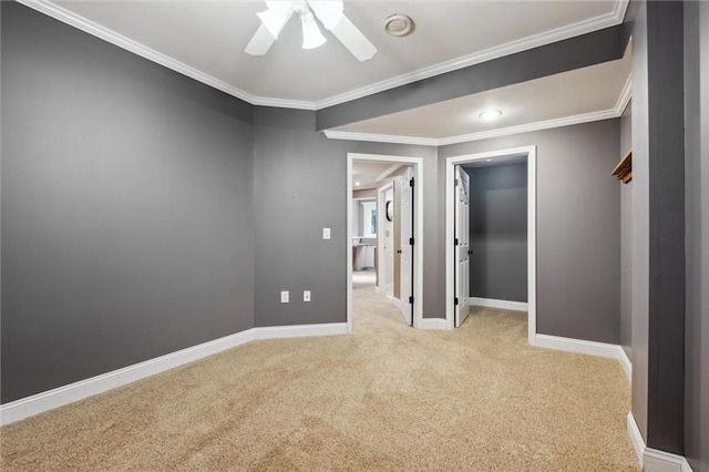 unfurnished room with carpet, ceiling fan, ornamental molding, and baseboards