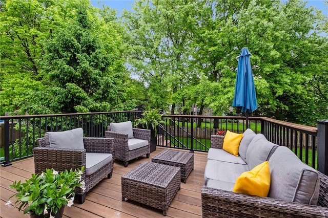 wooden deck with an outdoor living space and view of scattered trees
