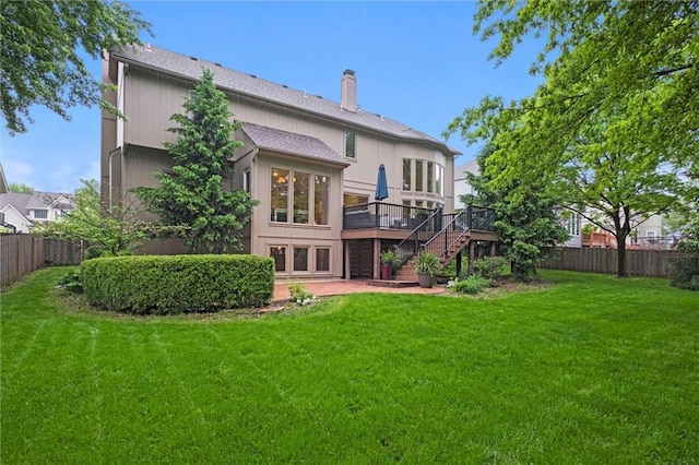 rear view of property with stairs, a wooden deck, a chimney, and a patio