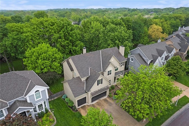 aerial view of residential area with a heavily wooded area