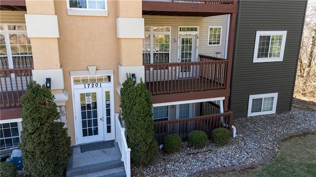 property entrance with stucco siding