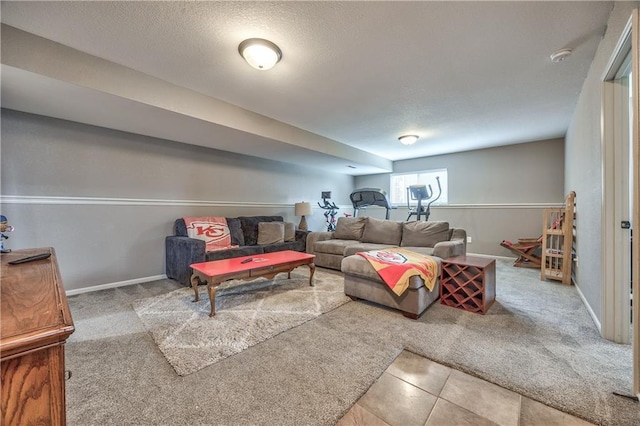 carpeted living room with a textured ceiling, baseboards, and tile patterned floors