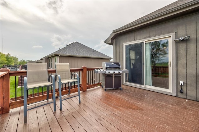 wooden terrace with a grill