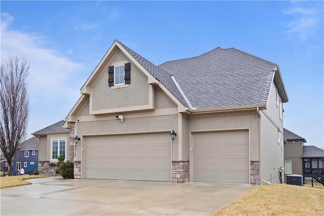 craftsman inspired home with cooling unit, driveway, stone siding, and stucco siding