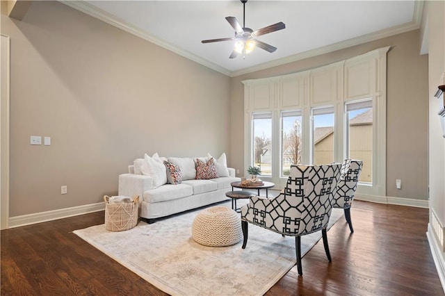 living area with ornamental molding, dark wood-style floors, and baseboards