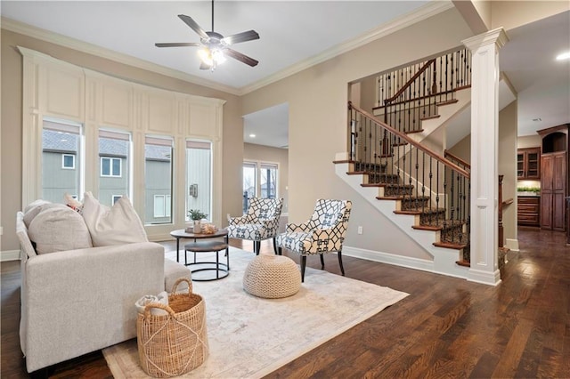 living room with wood finished floors, stairway, ceiling fan, baseboards, and ornate columns