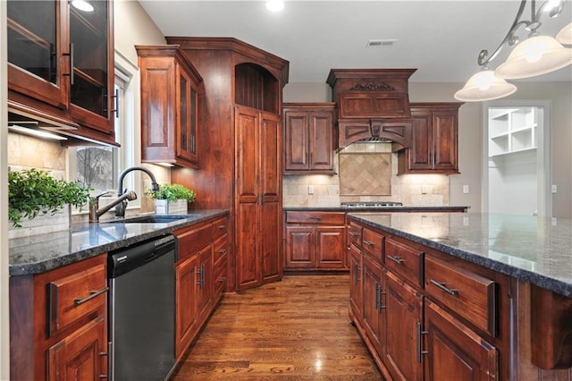 kitchen featuring tasteful backsplash, a sink, visible vents, stainless steel appliances, and dark wood finished floors