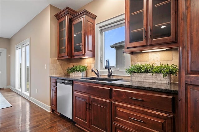 bar featuring decorative backsplash, dishwasher, dark wood-style floors, and a sink