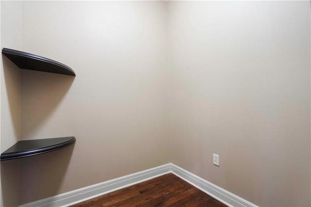 interior details featuring wood finished floors and baseboards