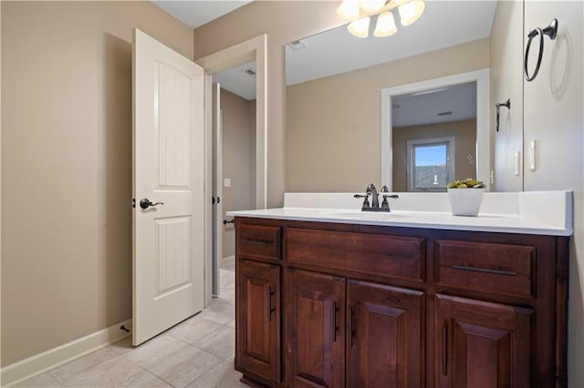 bathroom with tile patterned flooring, vanity, and baseboards