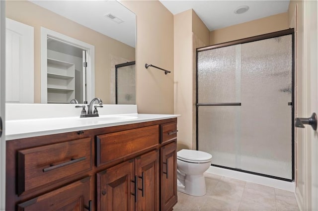 full bath with a shower stall, visible vents, toilet, tile patterned floors, and vanity