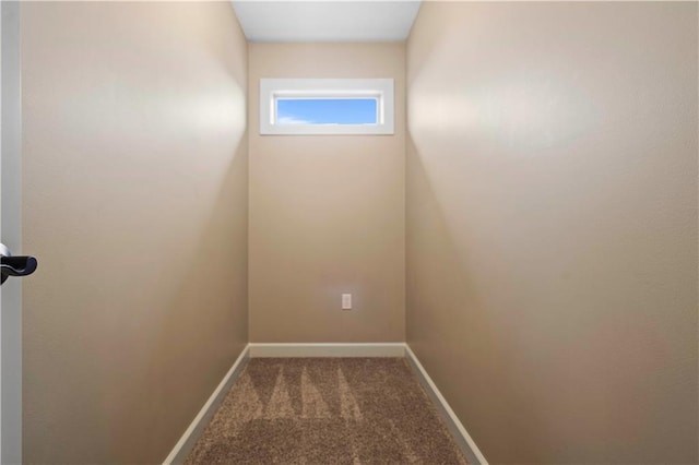 carpeted empty room with baseboards
