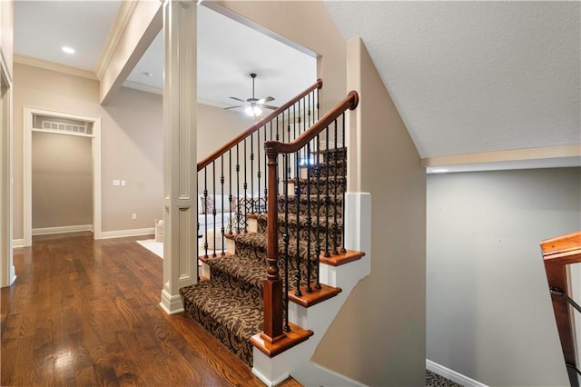 stairway featuring wood finished floors, ceiling fan, crown molding, and baseboards