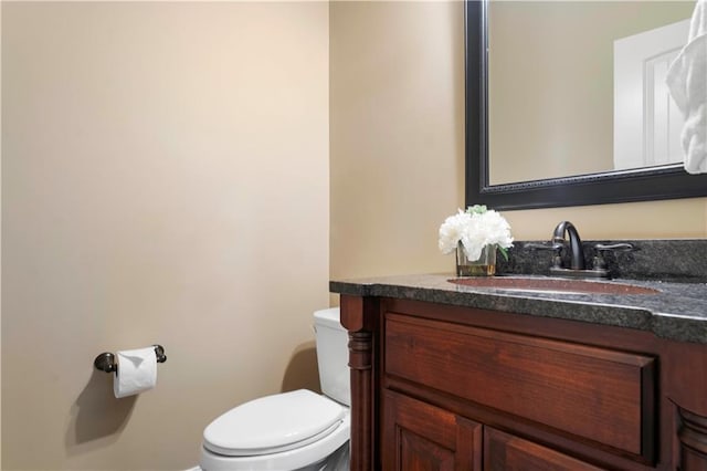 bathroom featuring toilet and vanity