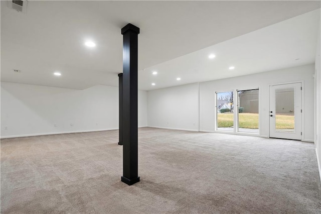 below grade area featuring recessed lighting, visible vents, and light carpet
