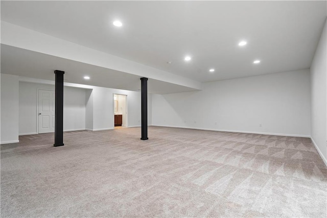 finished basement with baseboards, recessed lighting, and light carpet