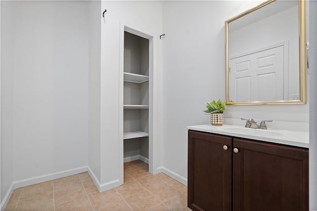 bathroom featuring vanity, tile patterned floors, and baseboards