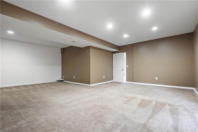 empty room with baseboards, recessed lighting, and carpet