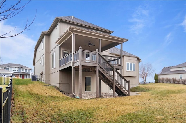 back of property featuring stairway, a deck, a ceiling fan, and a yard