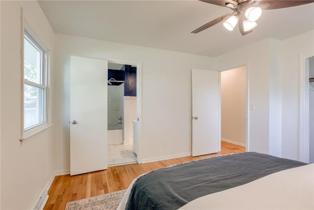 4401 E 104th St, Kansas City, MO 64137 - bedroom with wood finished floors, baseboards, ceiling fan, and baseboard heating