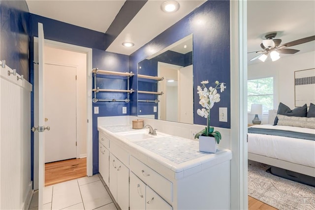 4401 E 104th St, Kansas City, MO 64137 - bathroom with connected bathroom, vanity, ceiling fan, tile patterned flooring, and recessed lighting