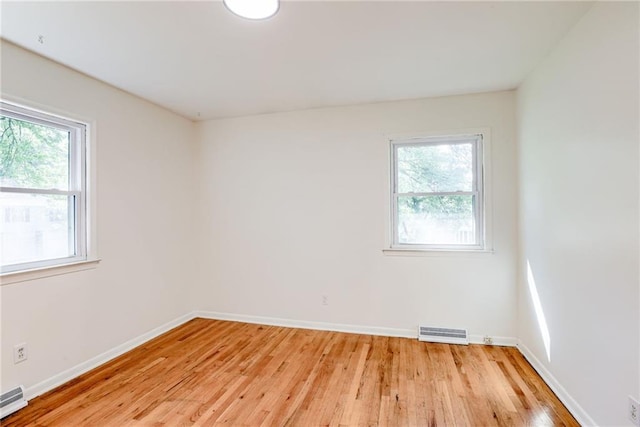 4401 E 104th St, Kansas City, MO 64137 - unfurnished room with light wood-style floors, baseboards, and a baseboard radiator