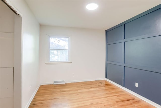 4401 E 104th St, Kansas City, MO 64137 - unfurnished bedroom with light wood-type flooring, baseboards, and a closet