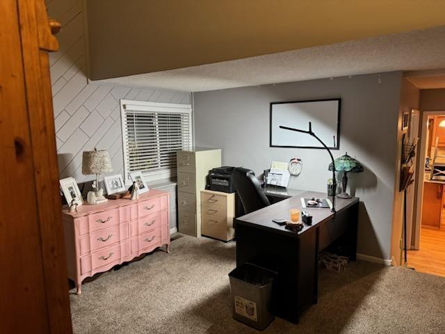 carpeted office featuring baseboards