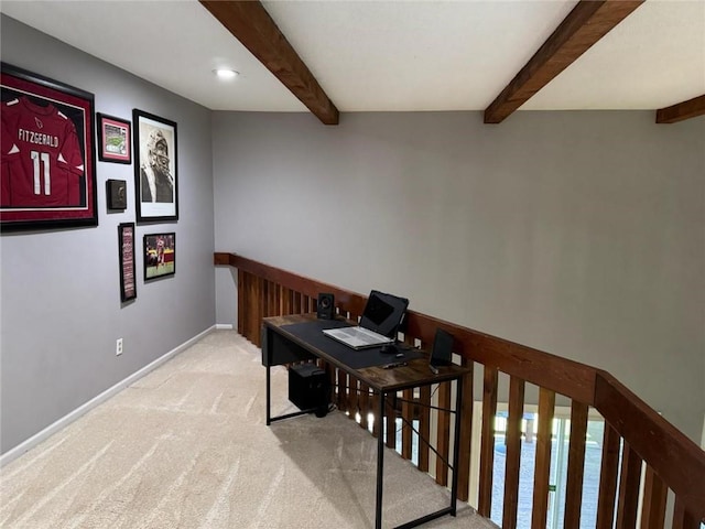 office area with carpet flooring, baseboards, and beam ceiling