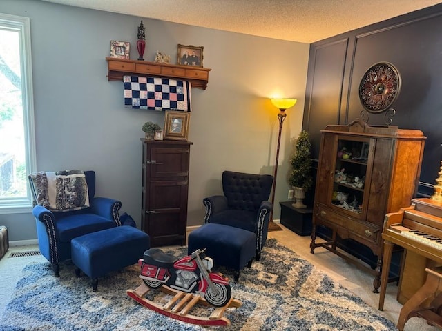 living area featuring carpet flooring, plenty of natural light, and visible vents