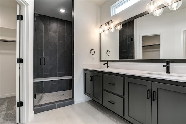 16488 S Stagecoach St, Olathe, KS 66062 - full bath featuring a stall shower, baseboards, double vanity, a walk in closet, and tile patterned floors