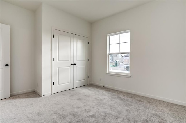 16488 S Stagecoach St, Olathe, KS 66062 - unfurnished bedroom with light colored carpet, baseboards, and a closet