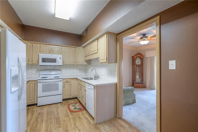 17800 E Bolger Rd Unit 245-A, Independence, MO 64055 - kitchen with white appliances, a sink, light countertops, backsplash, and a ceiling fan