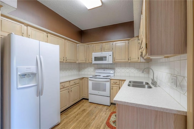 17800 E Bolger Rd Unit 245-A, Independence, MO 64055 - kitchen featuring white appliances, a sink, light wood-type flooring, light brown cabinetry, and a textured ceiling