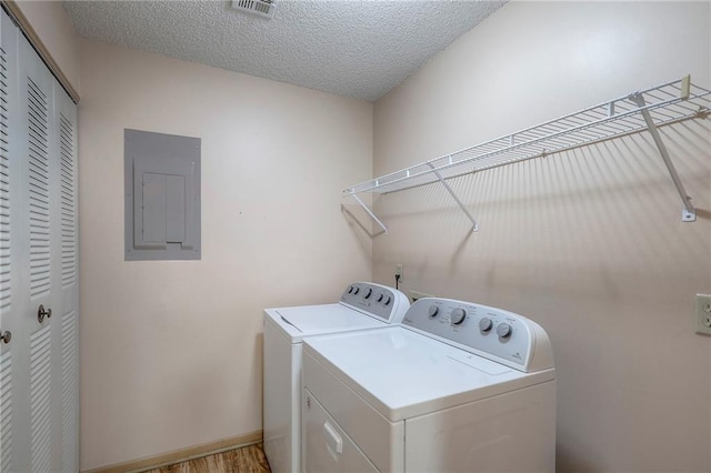 17800 E Bolger Rd Unit 245-A, Independence, MO 64055 - laundry area with electric panel, washer and clothes dryer, a textured ceiling, and light wood-style floors
