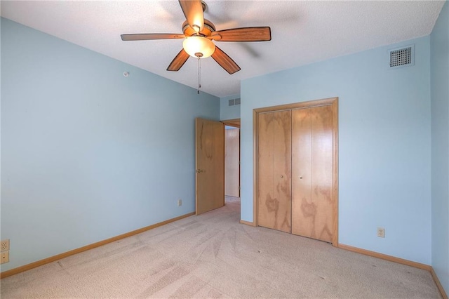 17800 E Bolger Rd Unit 245-A, Independence, MO 64055 - unfurnished bedroom featuring carpet floors, a closet, baseboards, and a ceiling fan