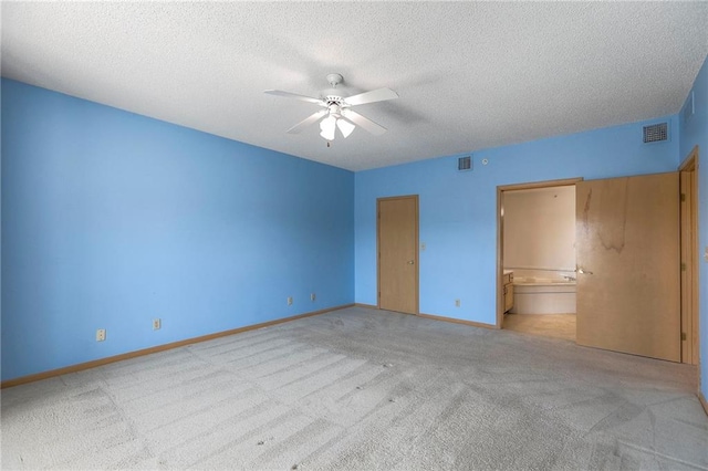 17800 E Bolger Rd Unit 245-A, Independence, MO 64055 - unfurnished bedroom featuring carpet flooring, a textured ceiling, baseboards, ensuite bath, and ceiling fan