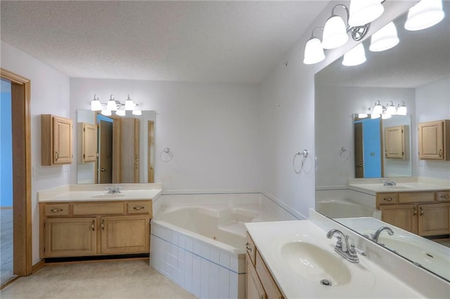 17800 E Bolger Rd Unit 245-A, Independence, MO 64055 - bathroom with a bath, two vanities, and a textured ceiling