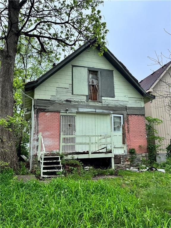 rear view of house featuring brick siding