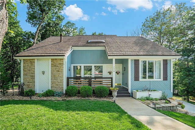 208 NE Landings Cir, Lees Summit, MO 64064 - view of front facade featuring a front yard, stone siding, and covered porch